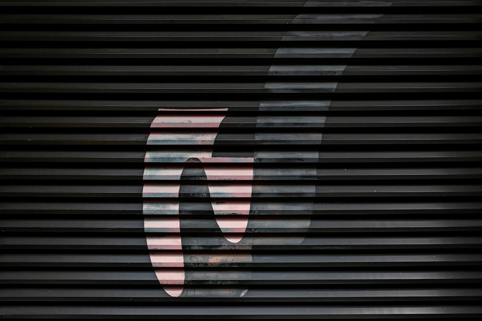 A bold graphic is behind a roller shutter.