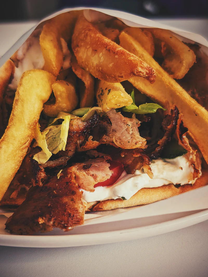 Greek gyros wrap filled with meat and chips