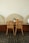 Two chairs and a small table in a cafe.