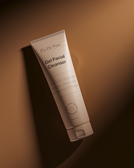 A tube of facial cleanser against a brown background.