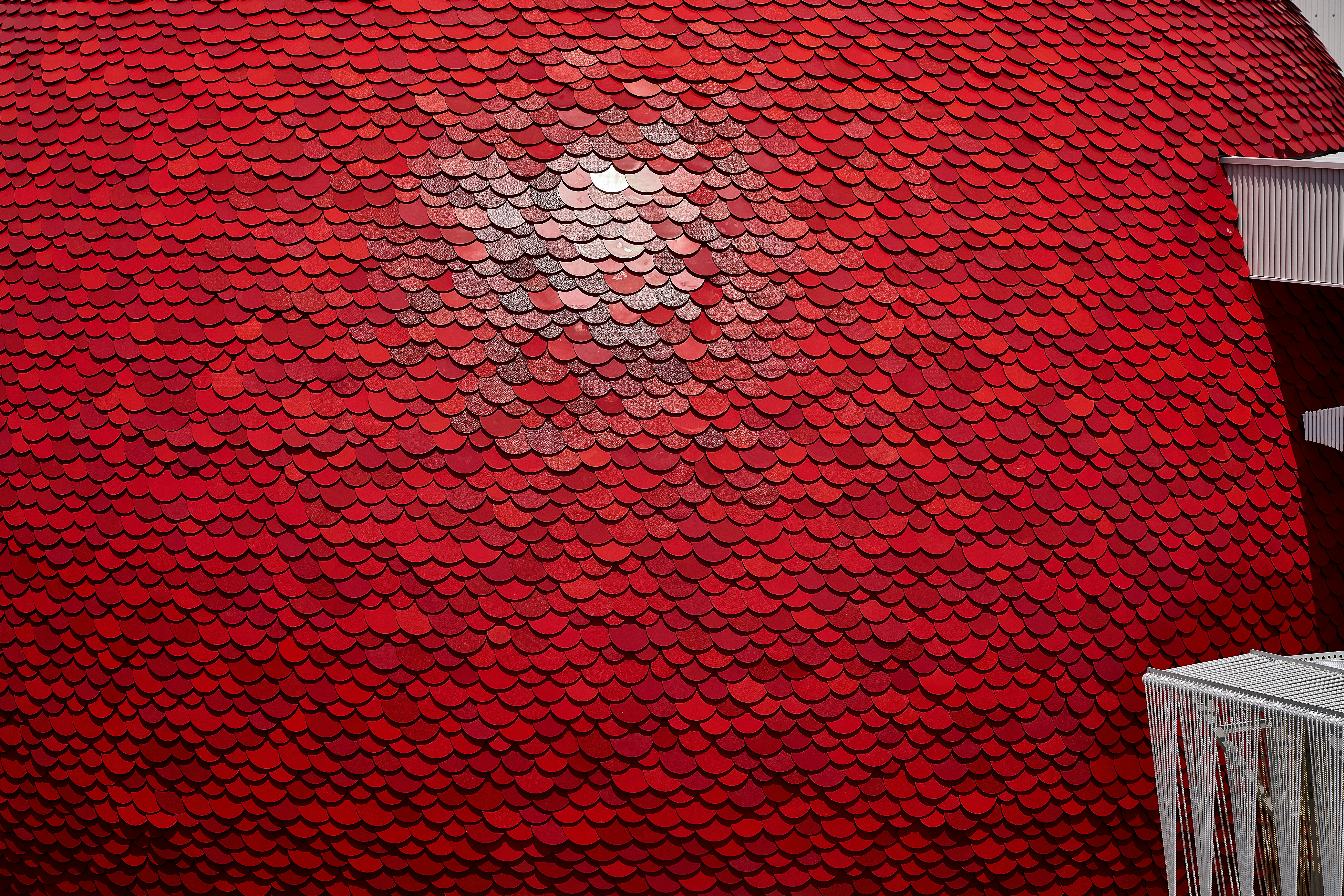 Red sequins form a colorful and textured pattern.