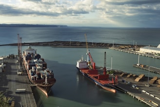 Ships are docked at a bustling industrial harbor.
