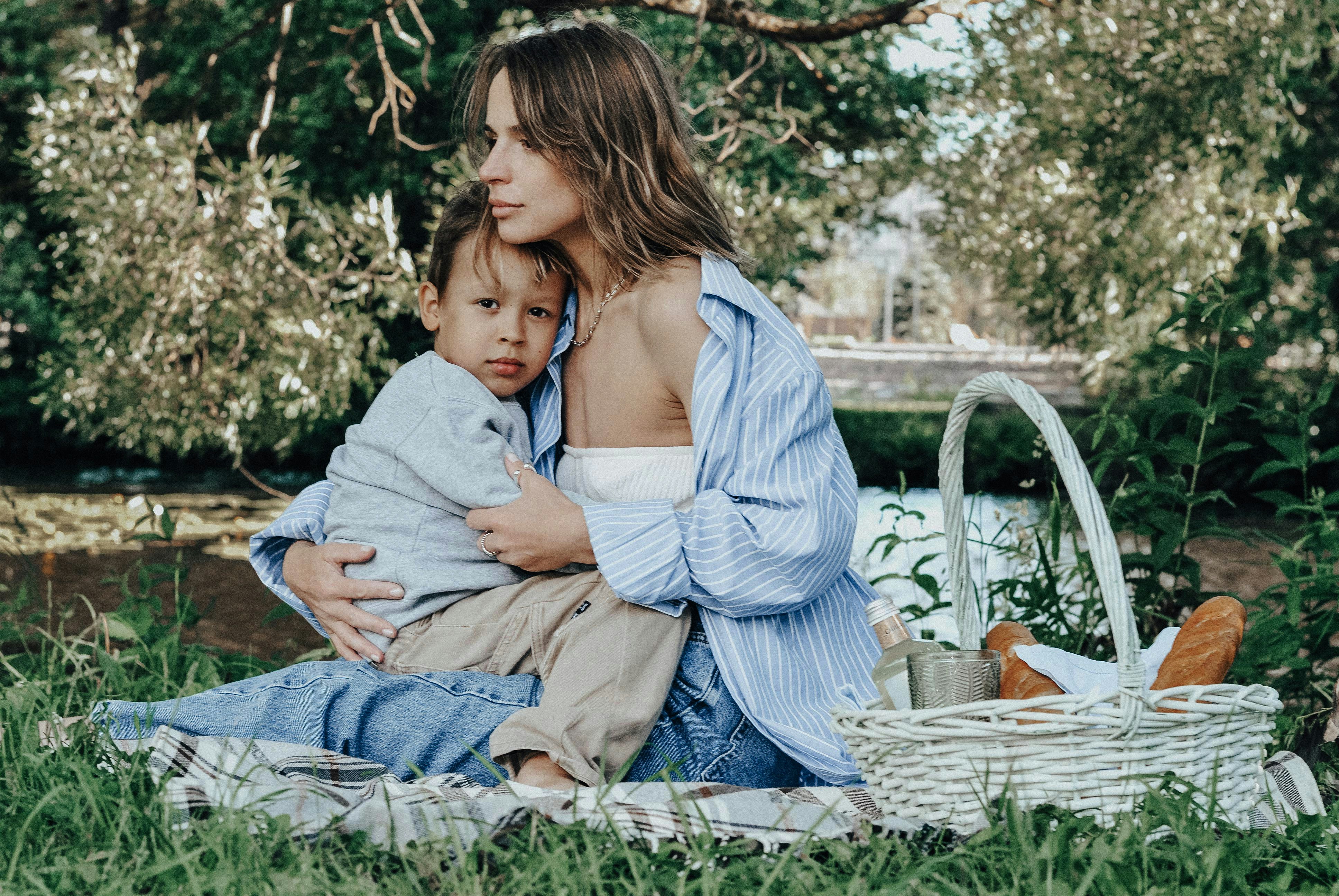 Mother and child enjoy a picnic outdoors.