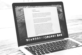 Laptop displays a document, possibly a letter.