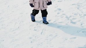 A child walks in the snowy terrain.