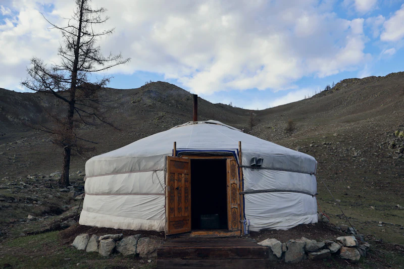 Ger camp in a green river valley