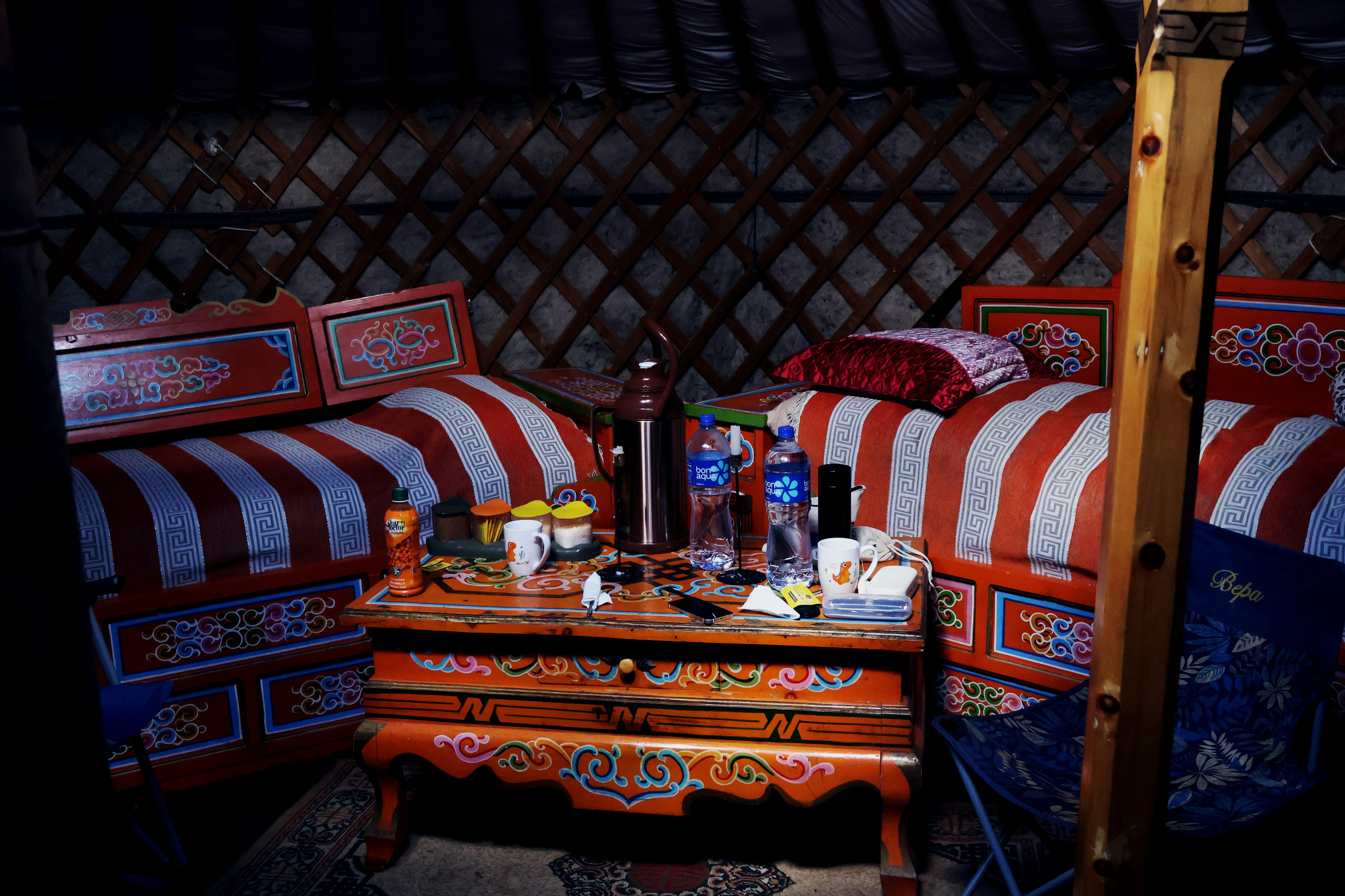 Inside of a decorated yurt with furniture.