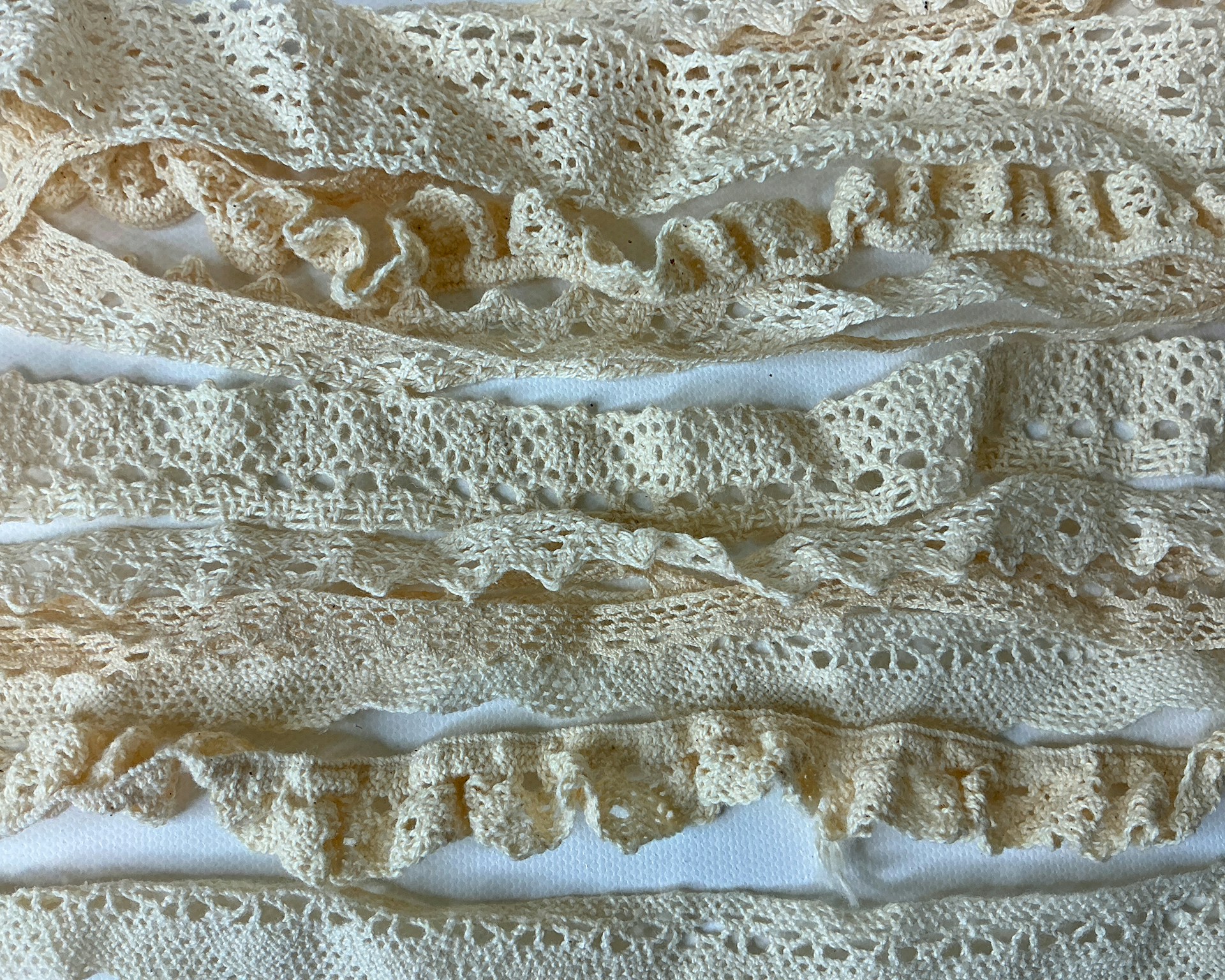 Cream-colored lace strips arranged horizontally.