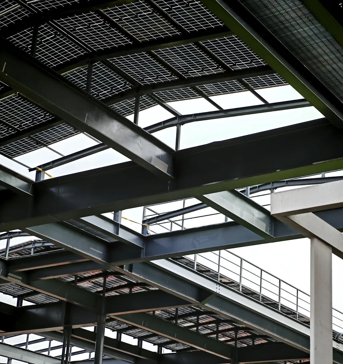 Exposed steel beams and roofing framework in a modern structural construction project.