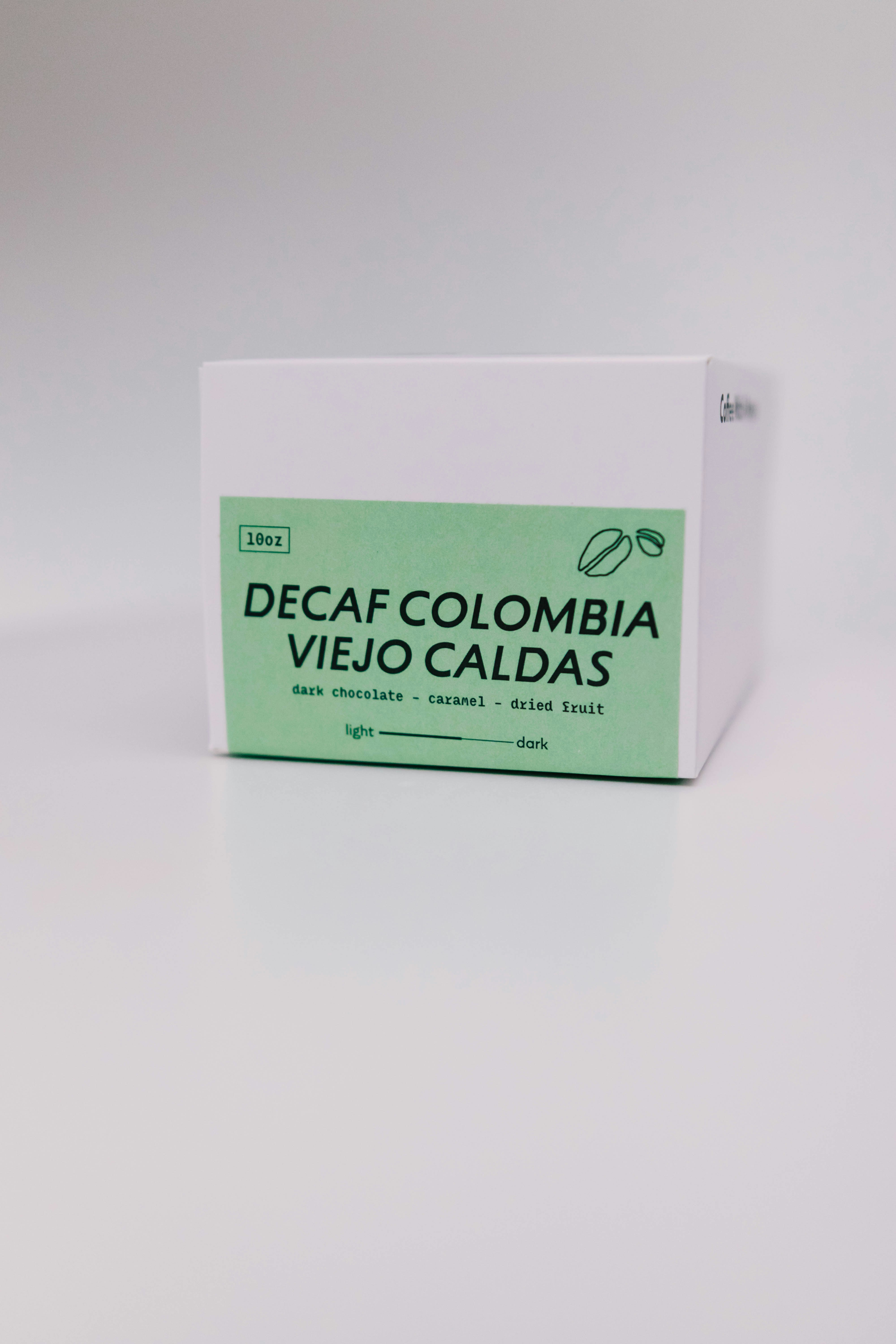 A box of decaf colombia coffee beans.