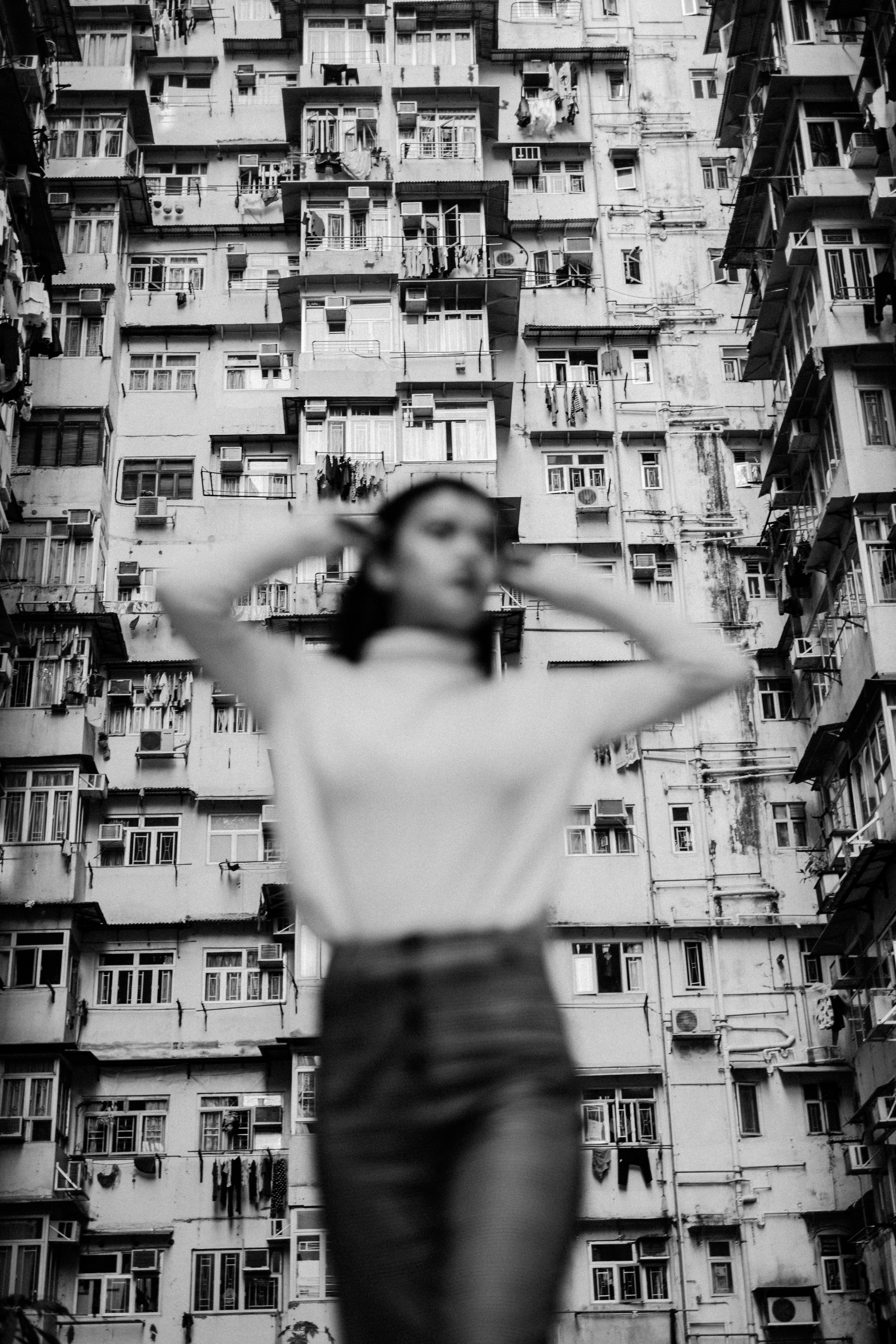 Woman poses in front of an apartment building