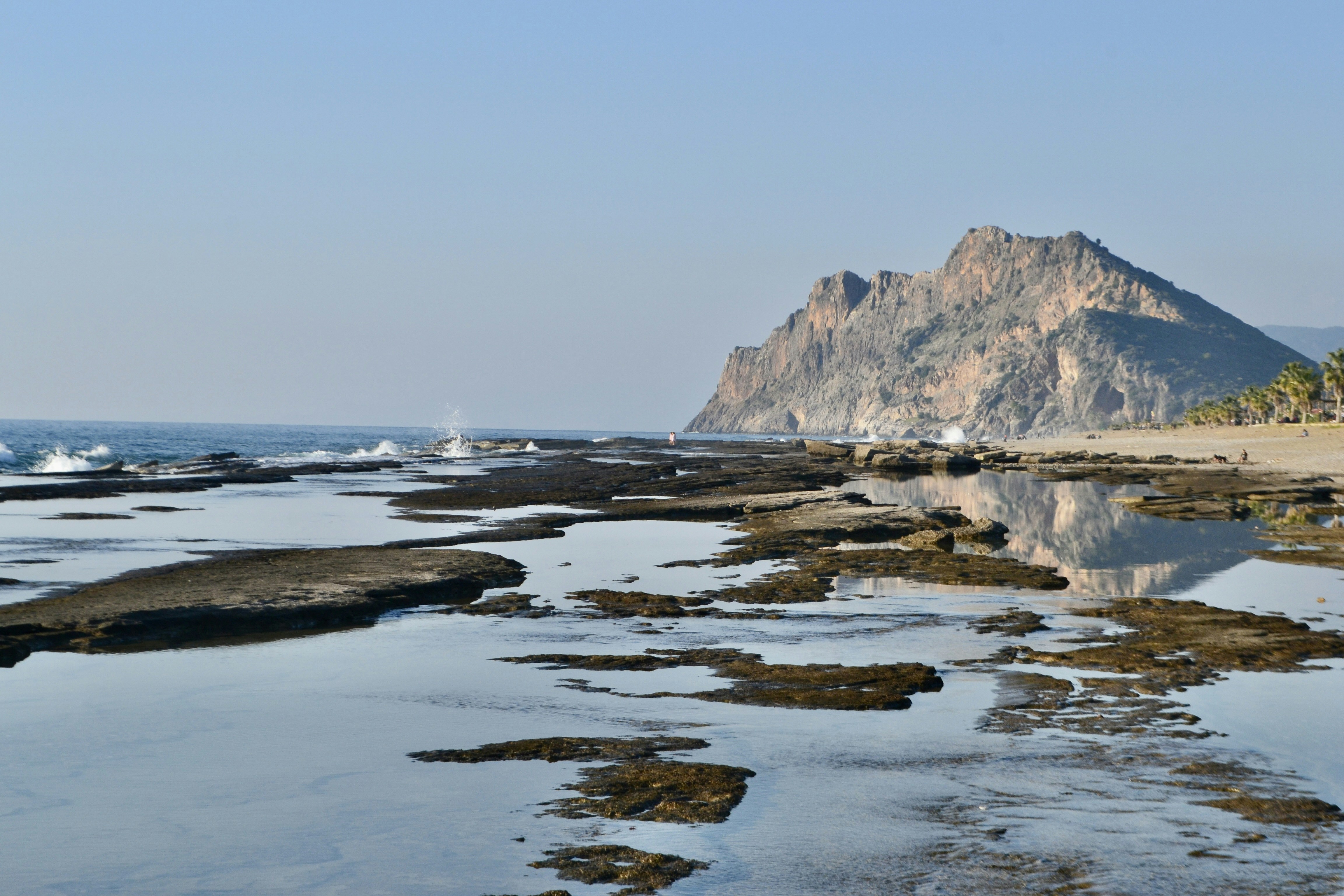 Rocky shore with a mountain in the distance.