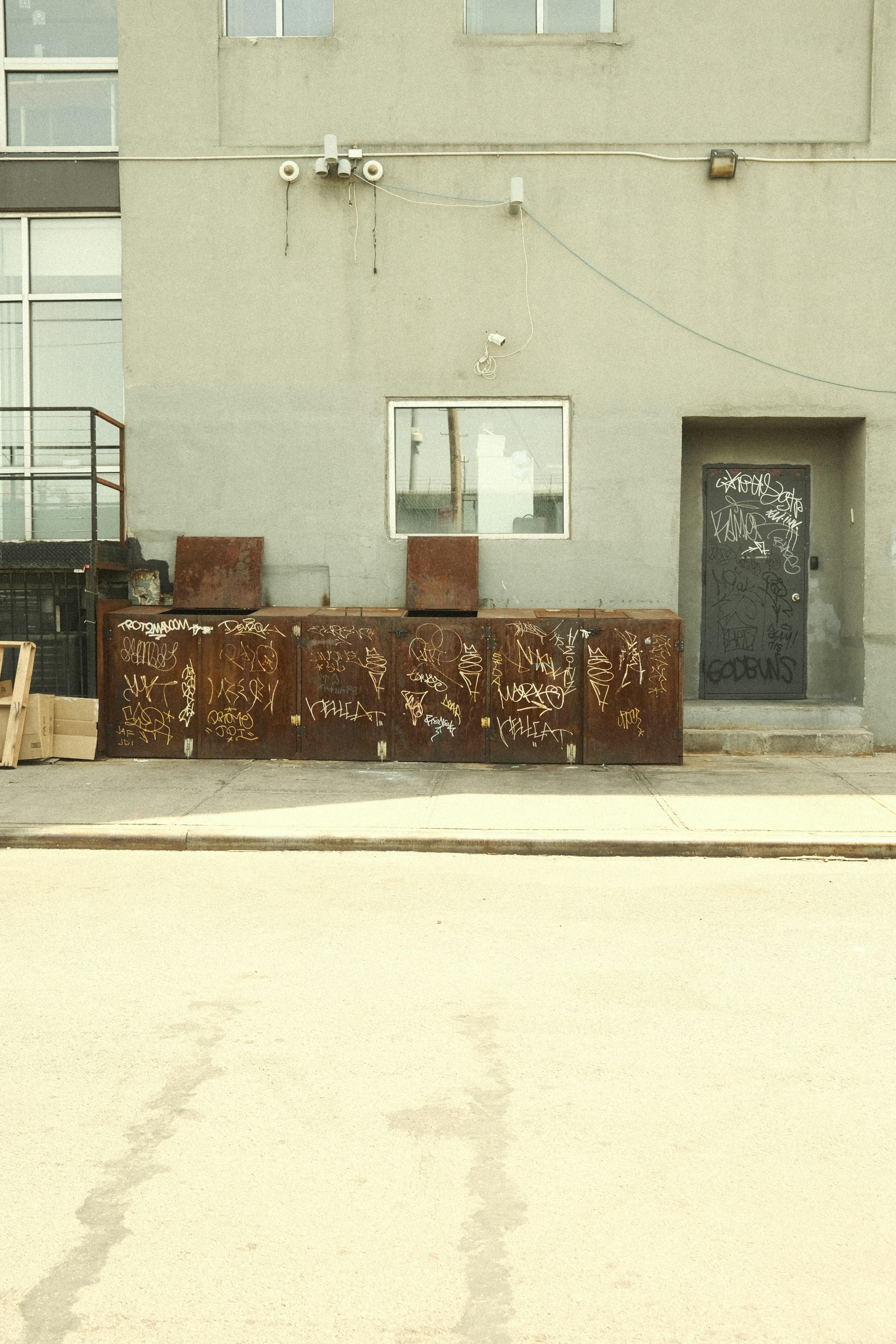 A building exterior with graffiti-covered metal.