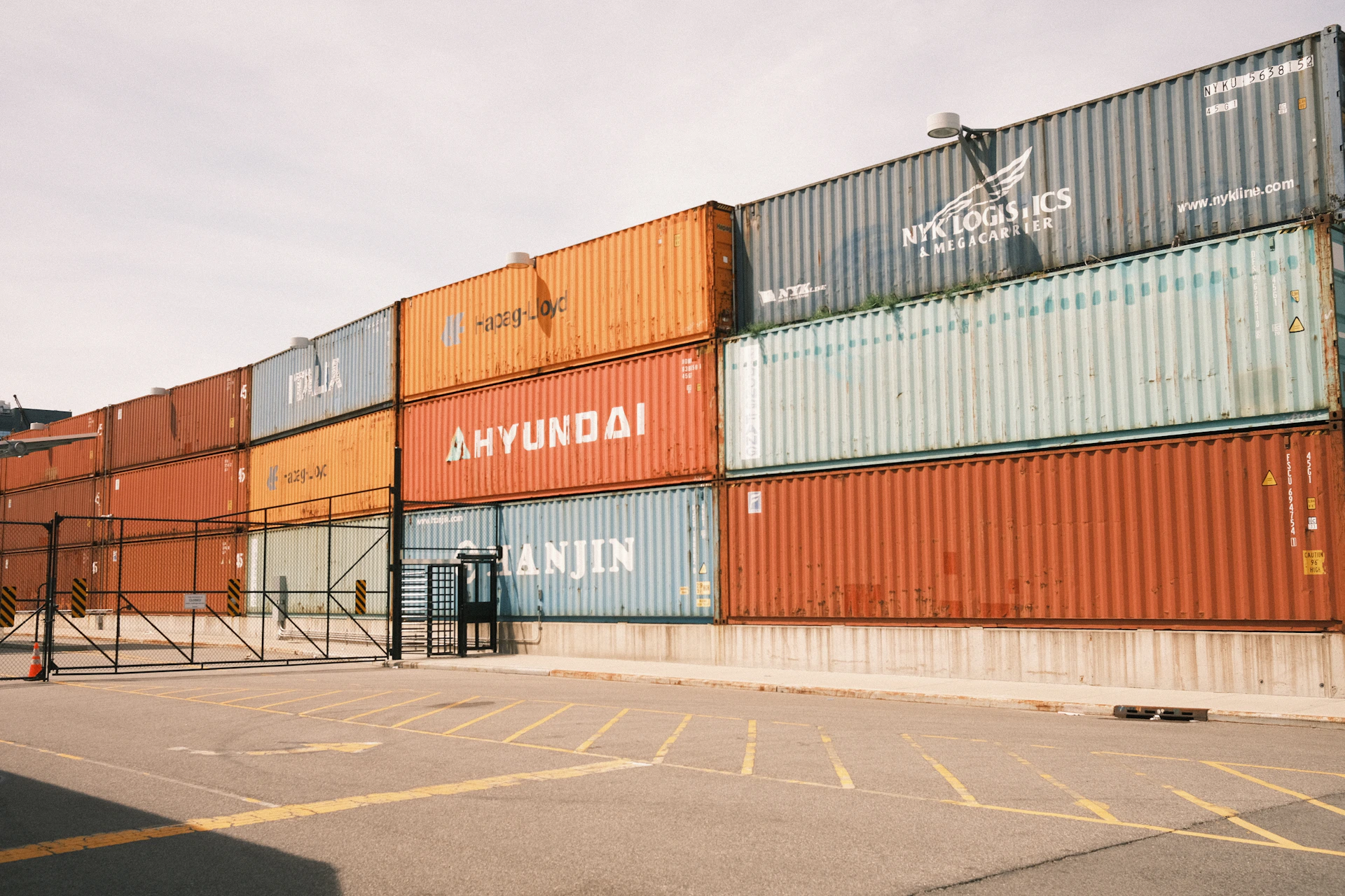 Cargo containers are stacked at a shipping yard.