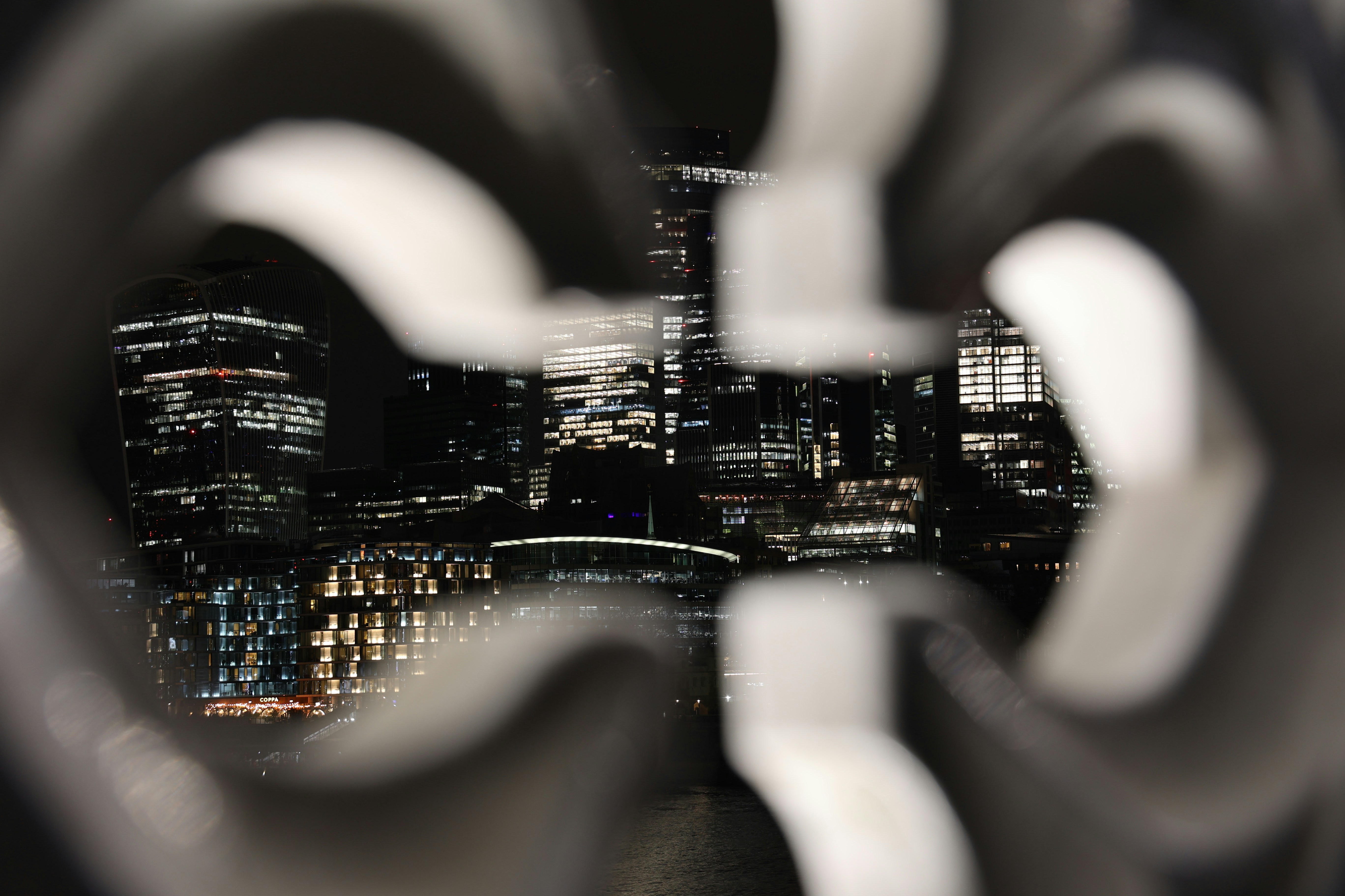 City lights seen through a blurred, patterned frame.