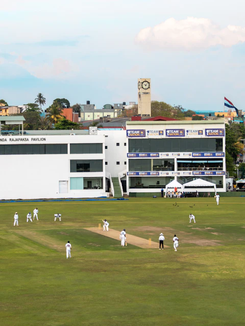 Cricket players on the field at a stadium