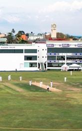 A cricket match is happening on the field.
