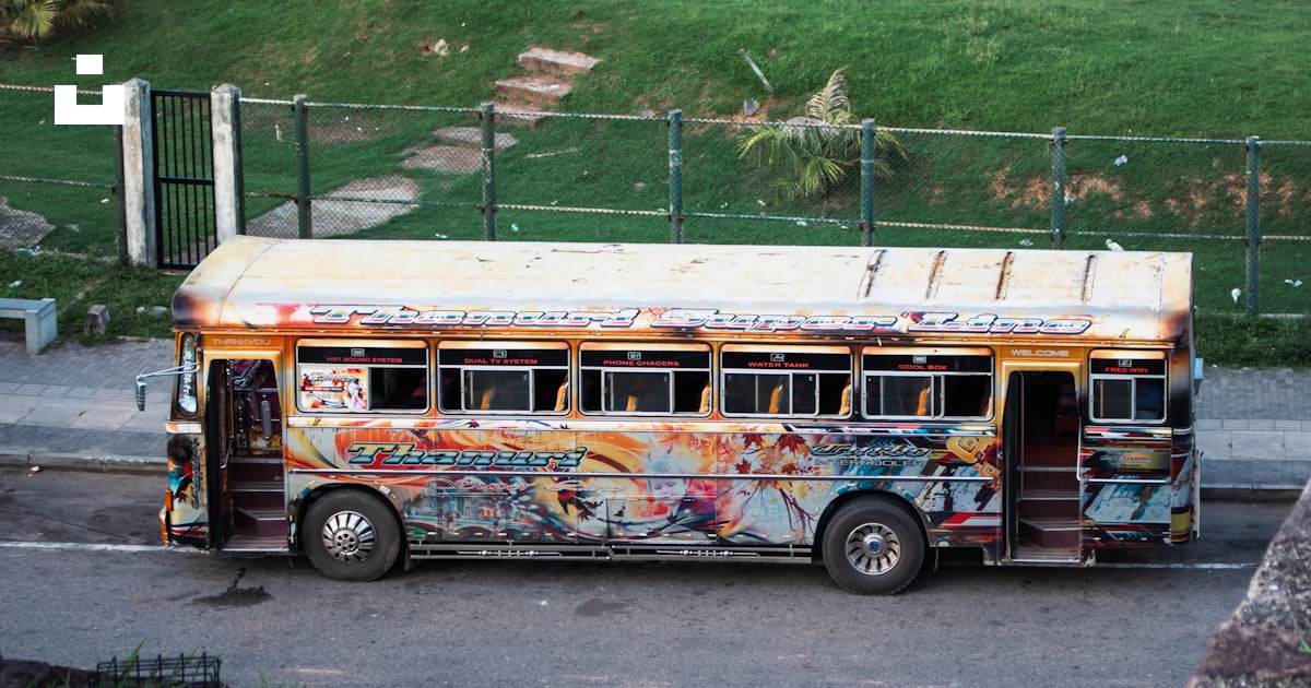 A colorful and painted bus is parked outdoors. photo – Free Travel ...