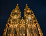 Cologne cathedral illuminated at night with a low angle view.