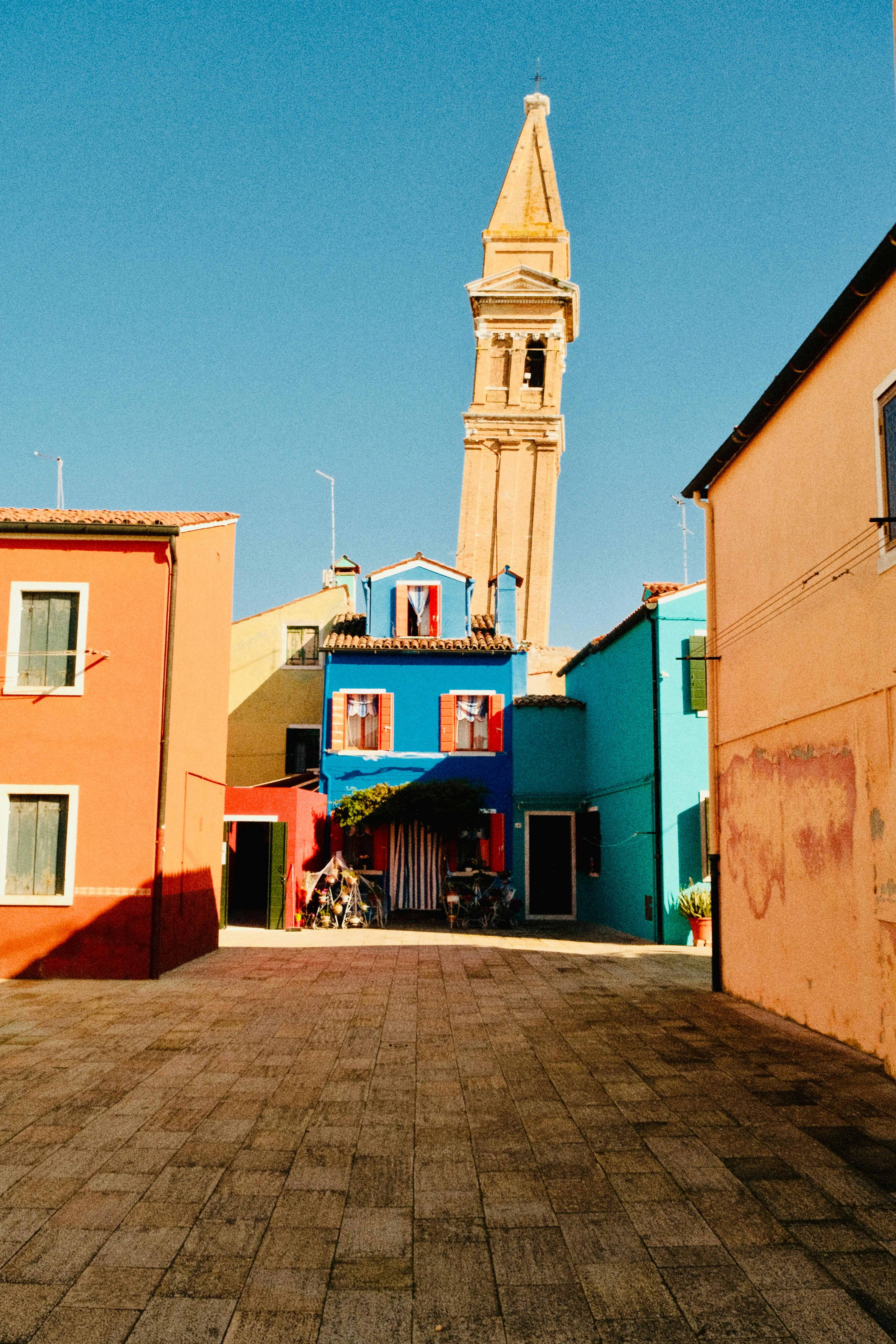 Colorful buildings and a leaning tower in burano.