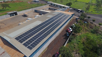 Solar panels cover a factory roof.