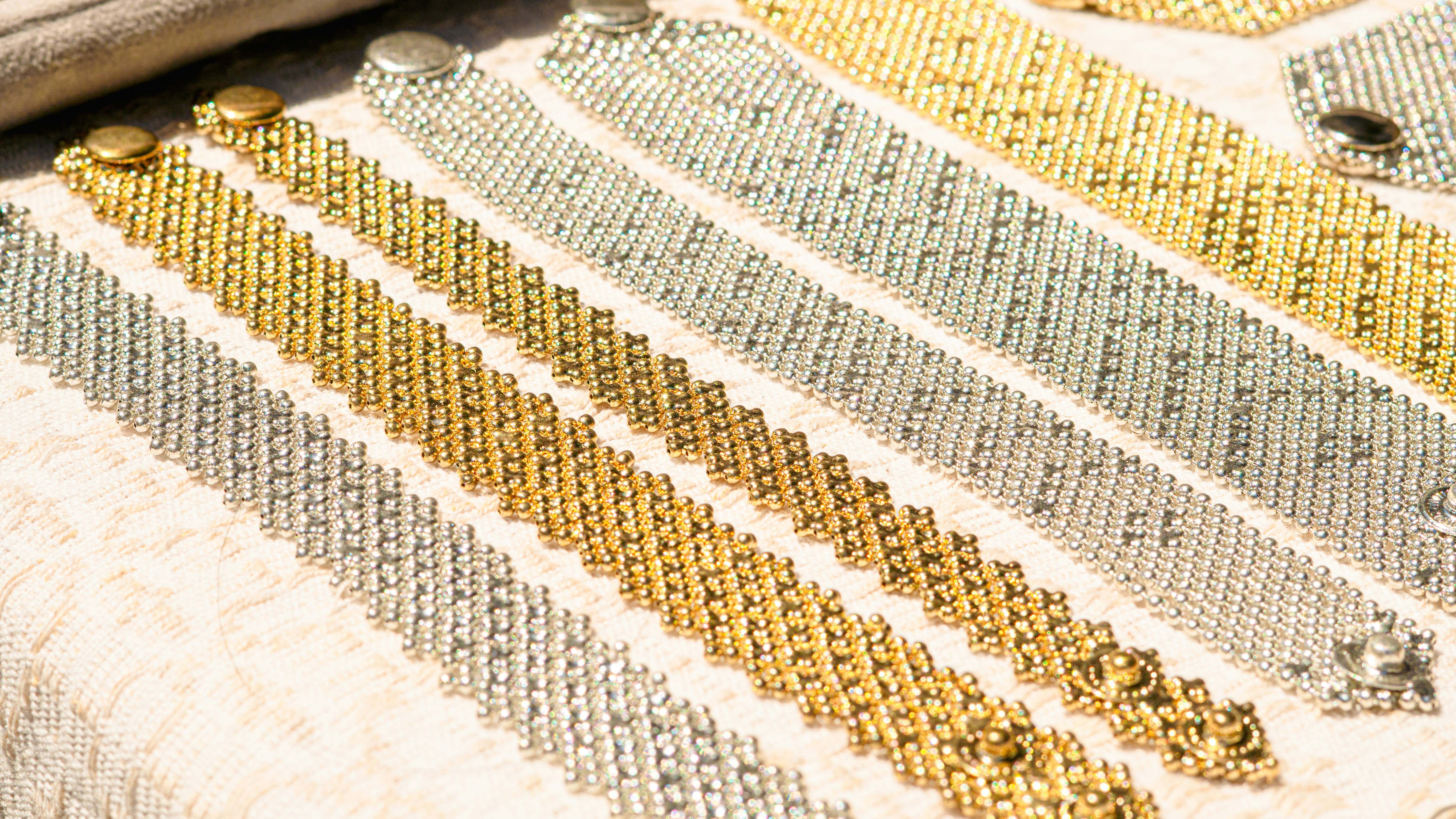 Gold and silver bracelets are displayed neatly.
