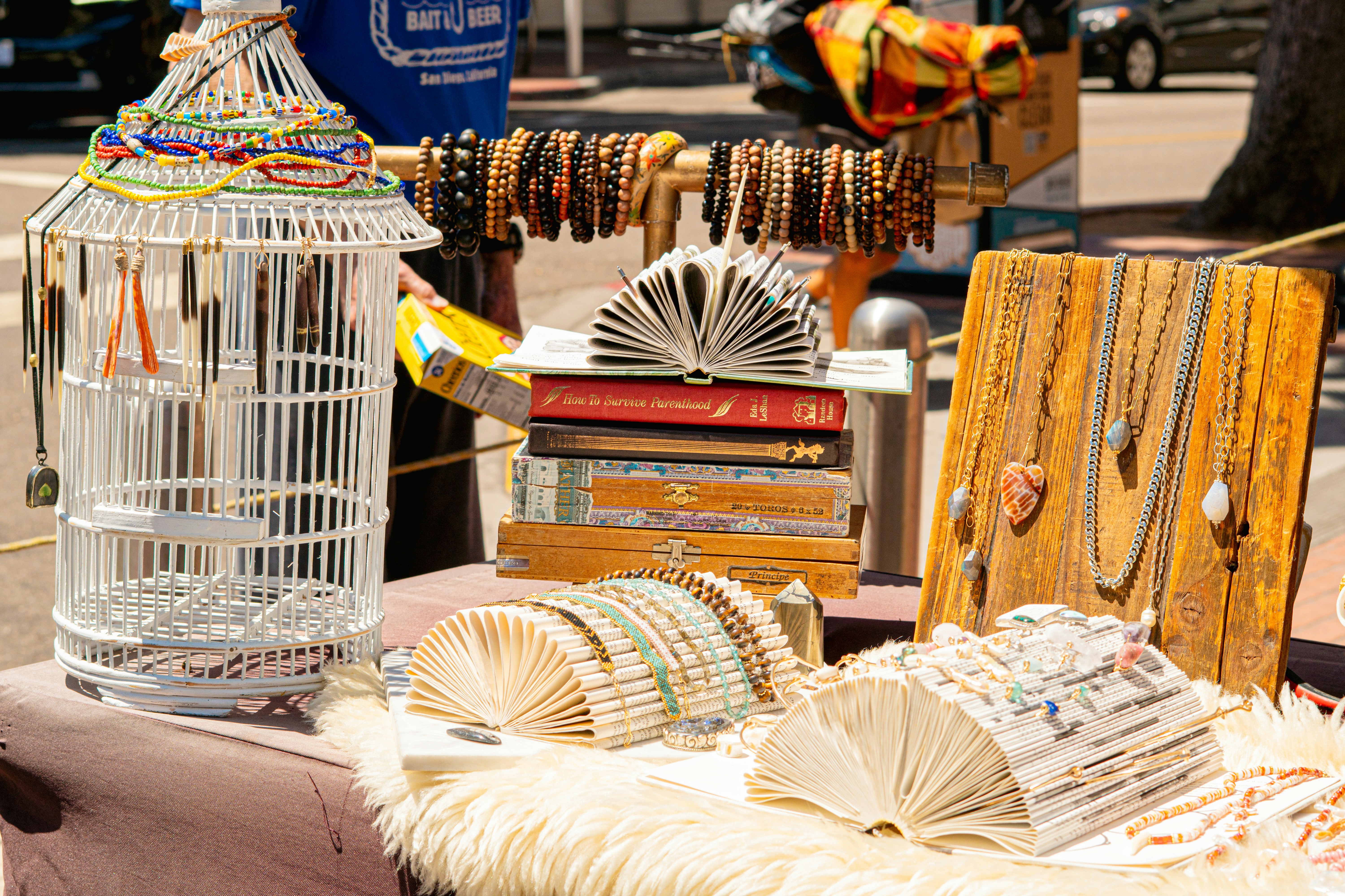 Jewelry and books displayed at an outdoor market