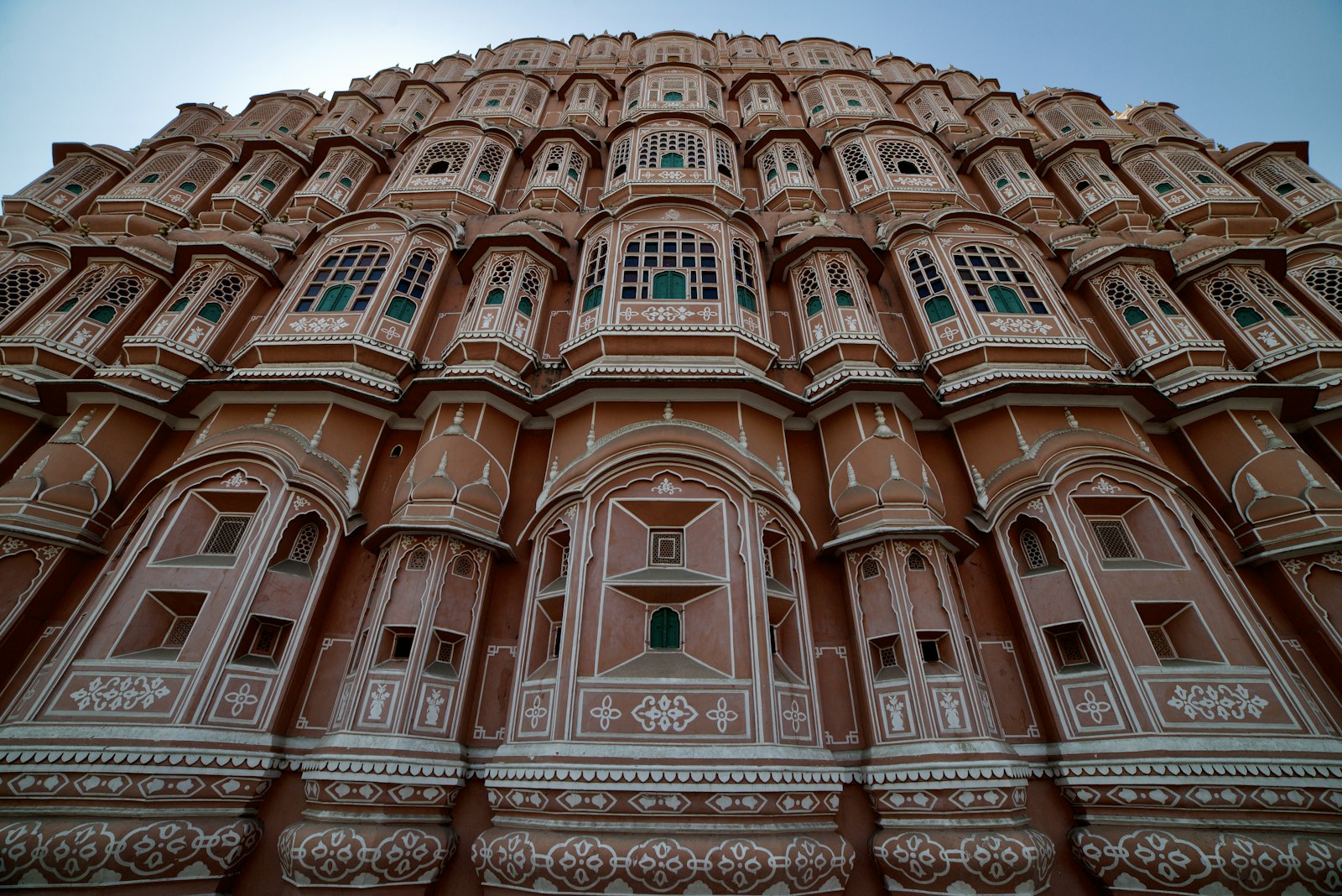 The pink sandstone honeycomb facade of Hawa Mahal, the Palace of Winds, in Jaipur