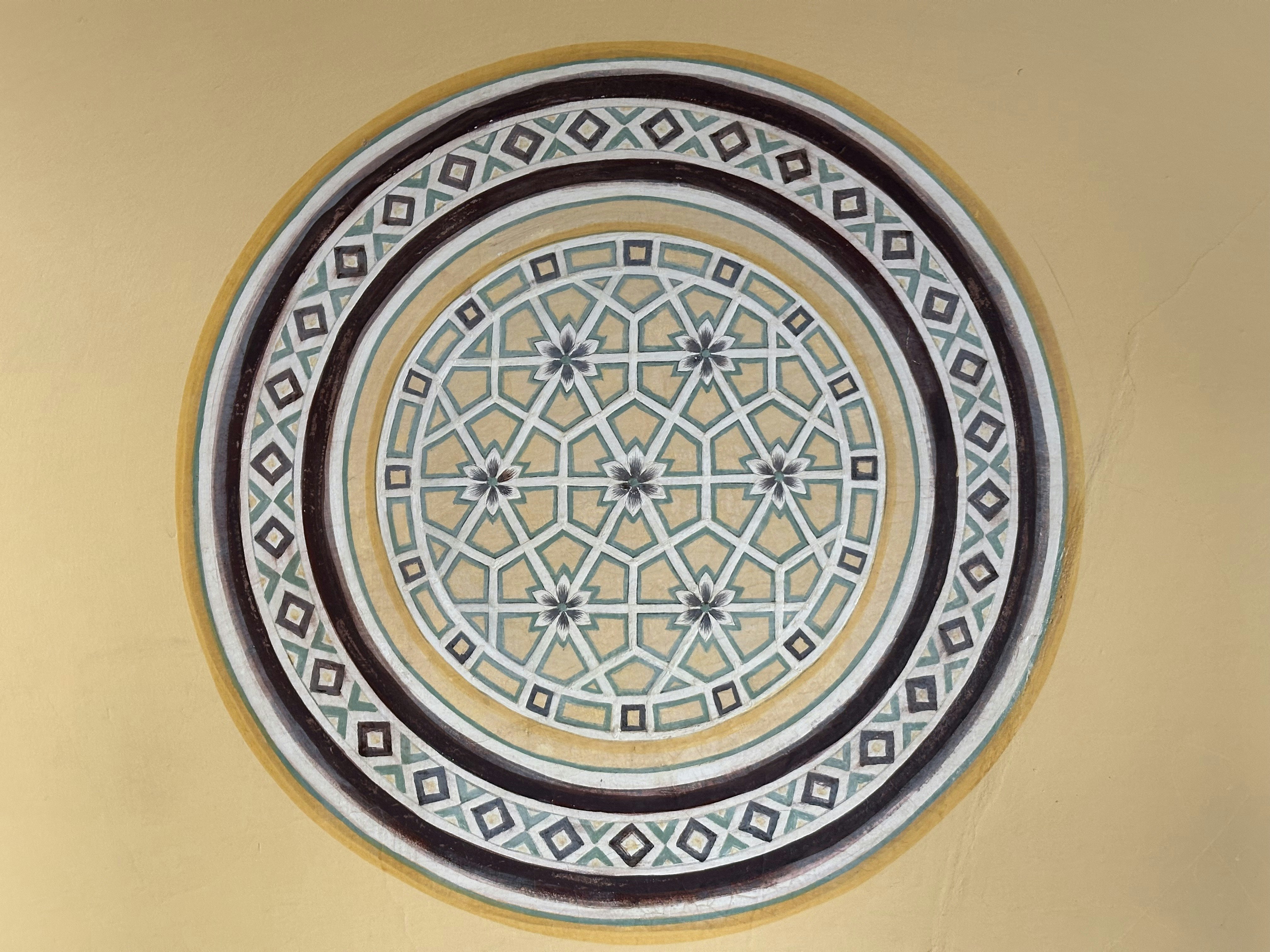 Ornate circular design with intricate patterns.
