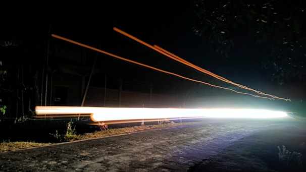 Long exposure photo of moving headlights at night.