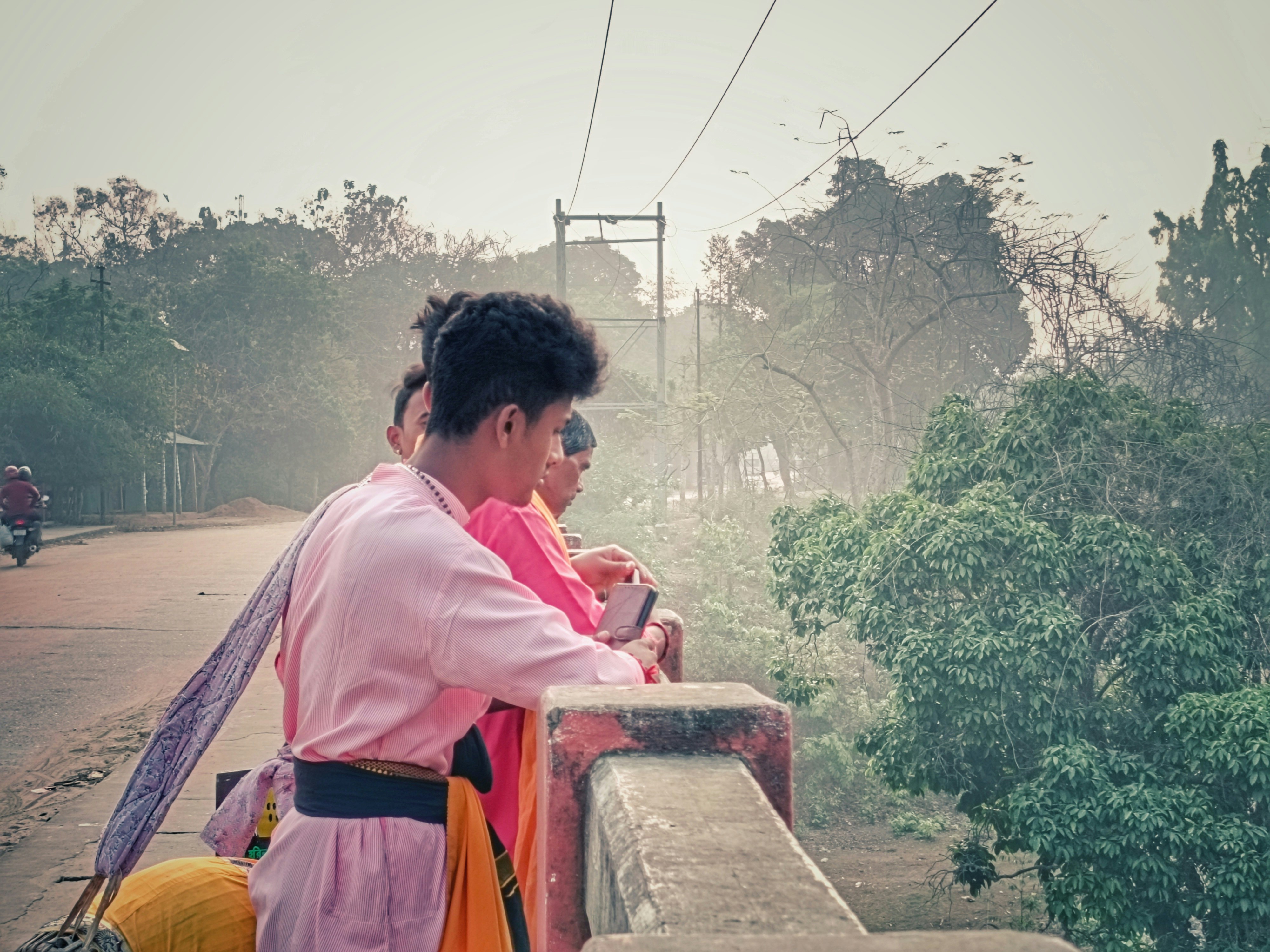 People are looking out at a bridge over a landscape.