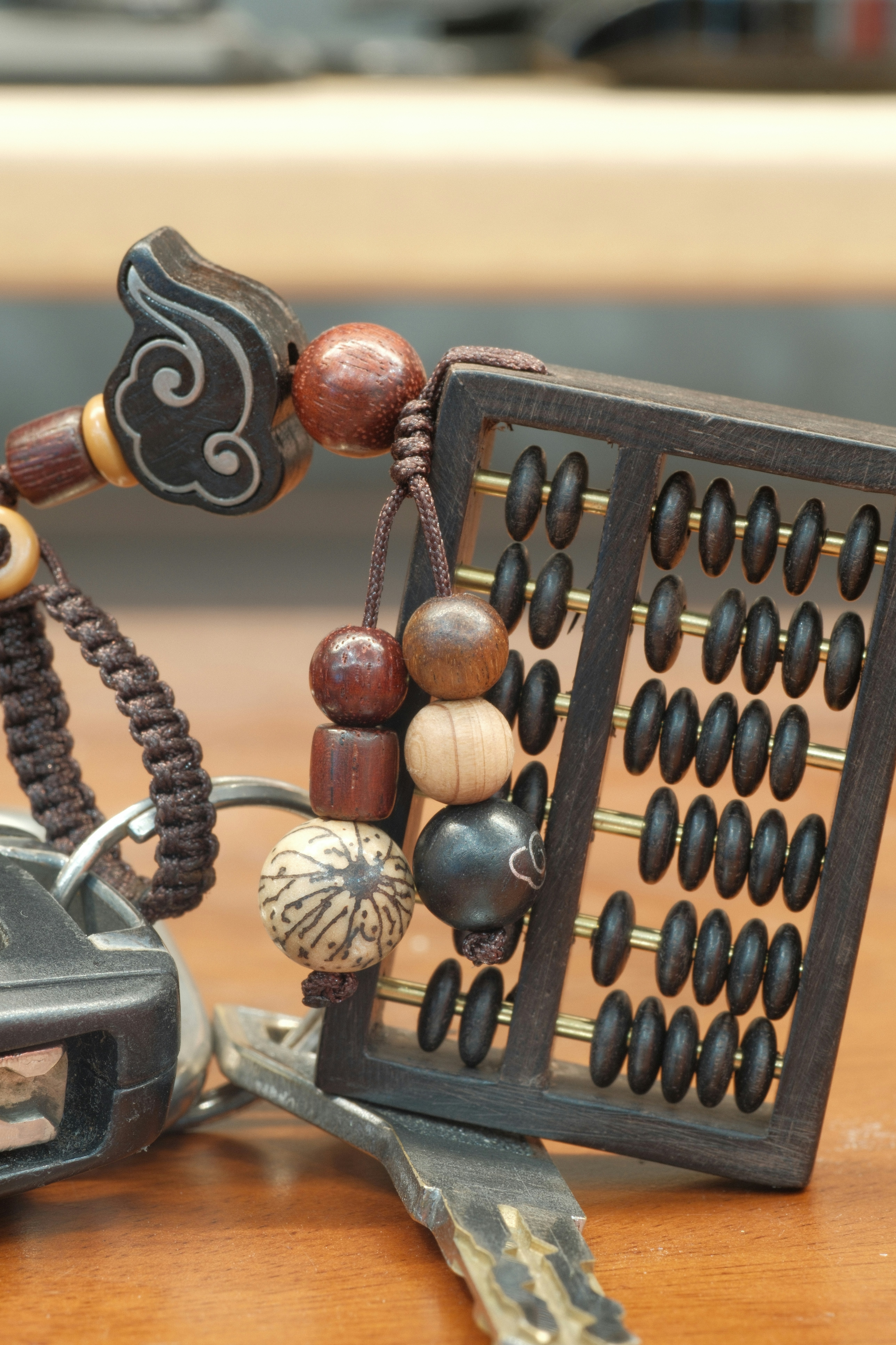 A miniature abacus charm on a keyring.