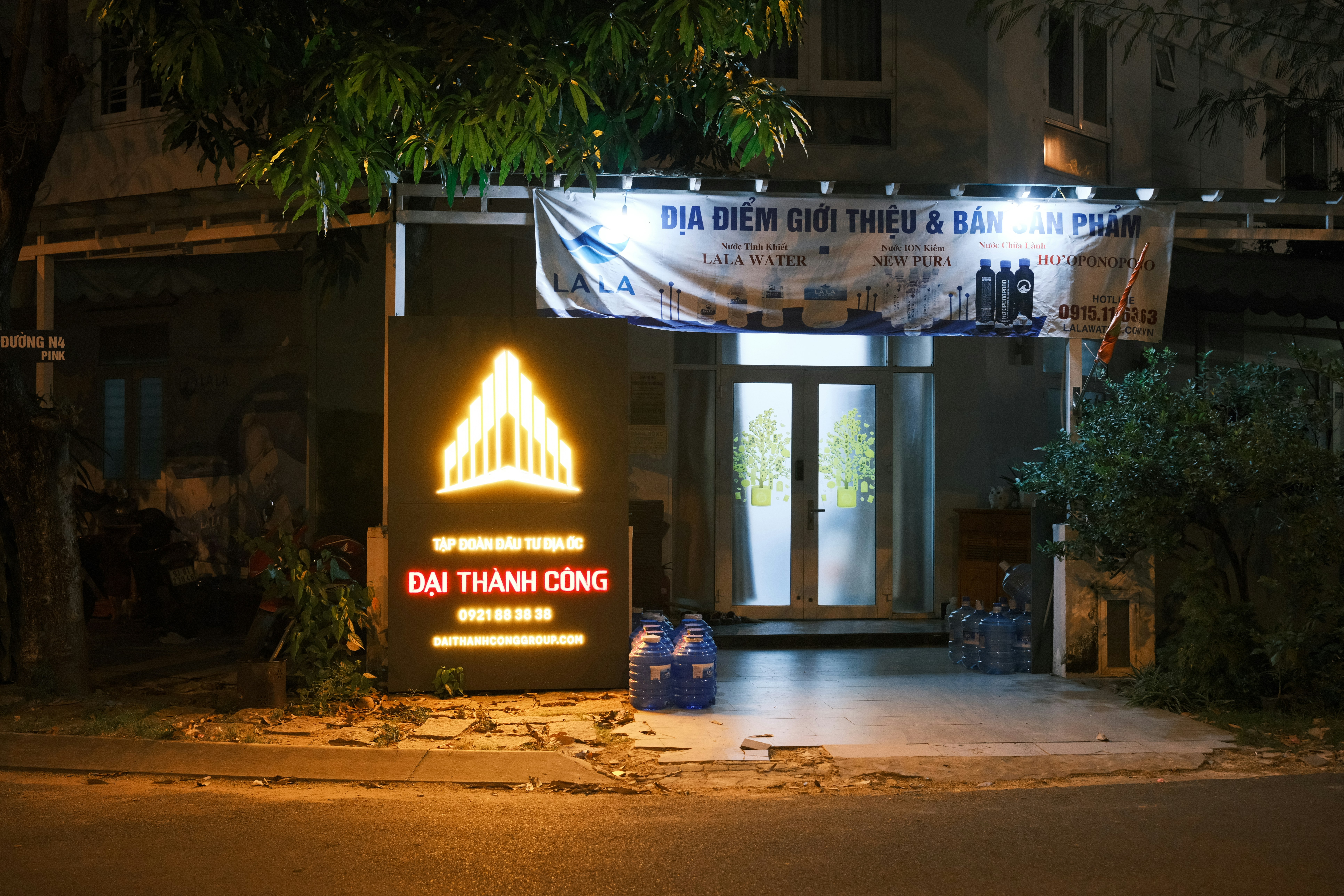 A building illuminated at night with a sign.