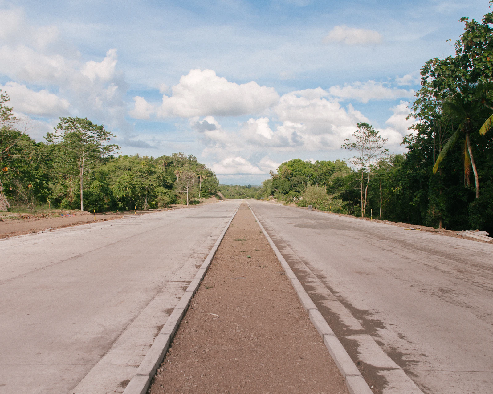 An open road between trees in Davao City, Philippines