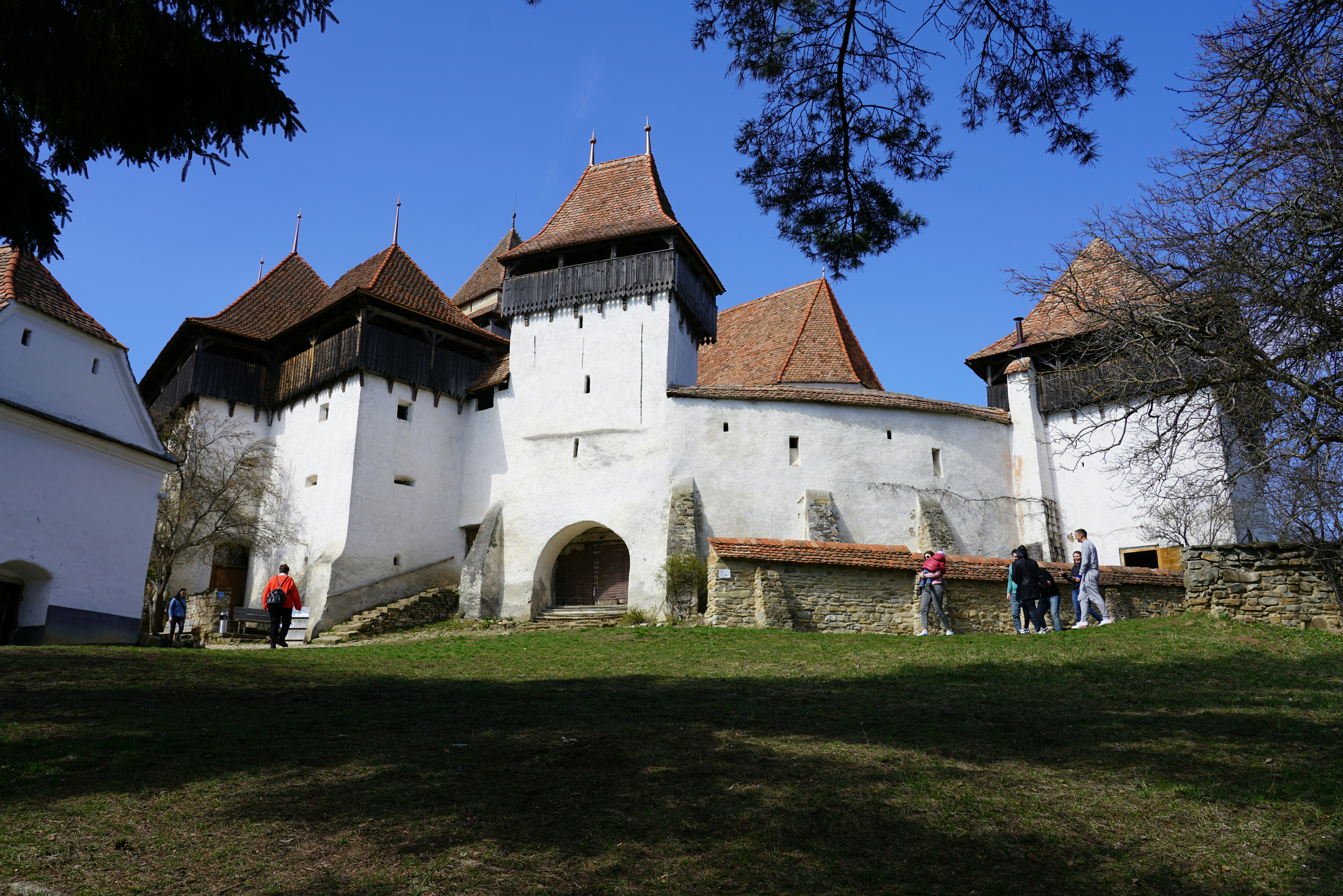 A white church with fortified walls stands proudly.