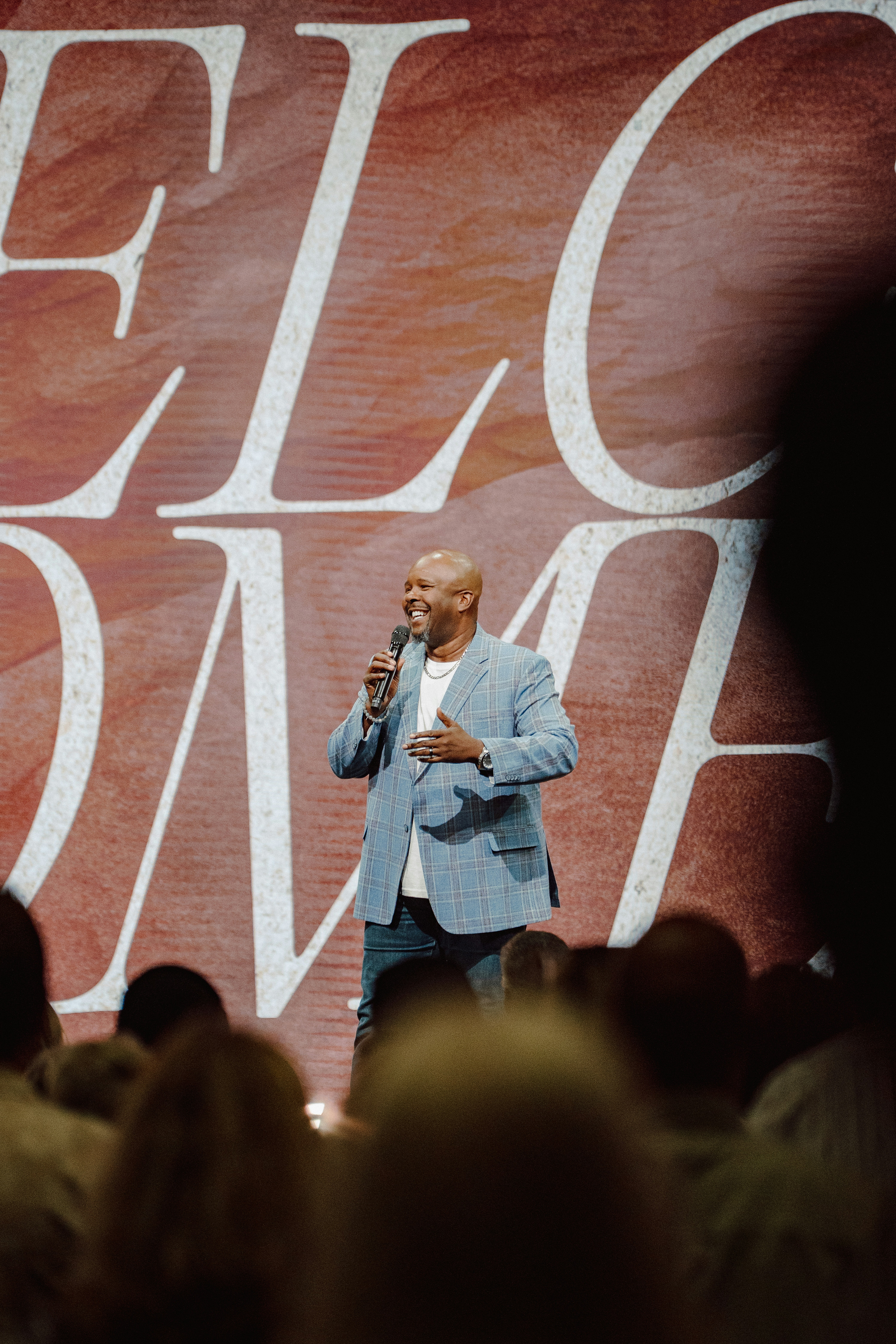 A man is speaking on stage at an event.