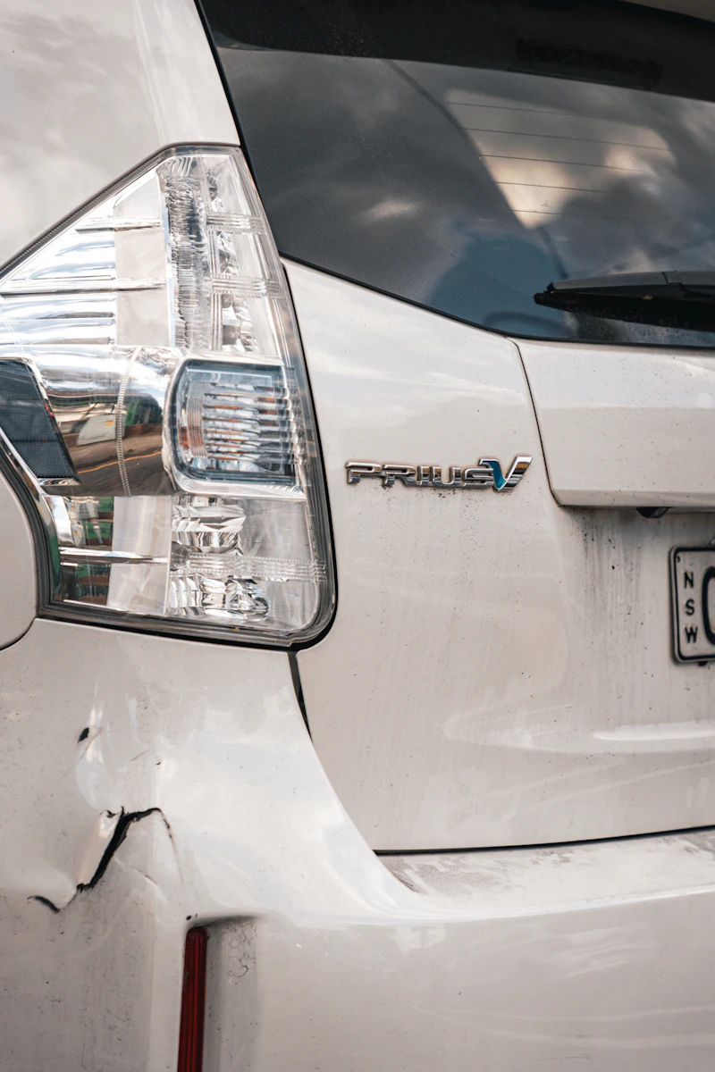 Dent in the rear of a green car
