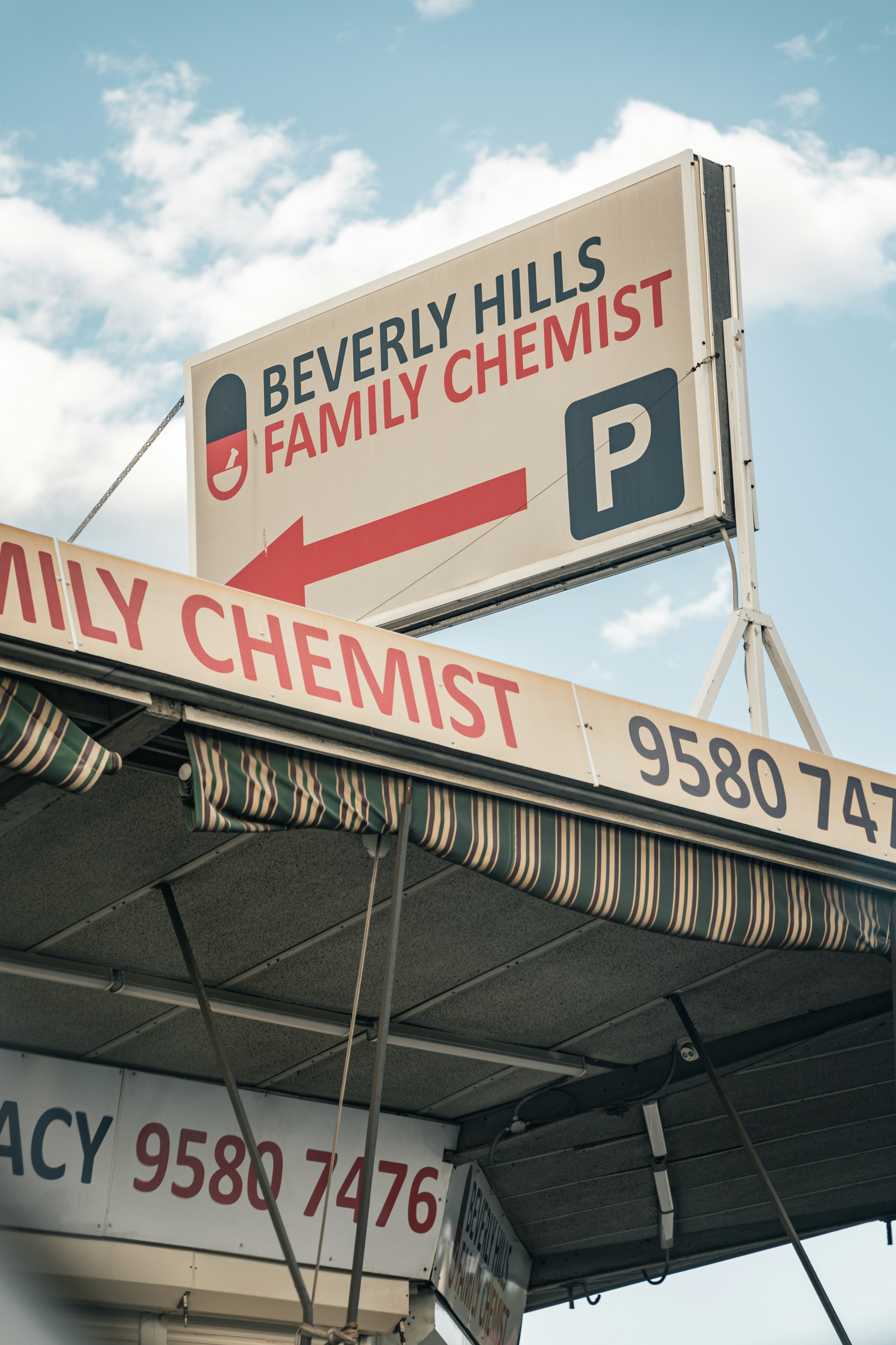 Beverly hills family chemist sign points towards parking