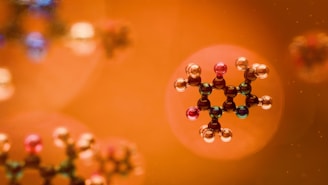 Molecular structures are seen against an orange backdrop.