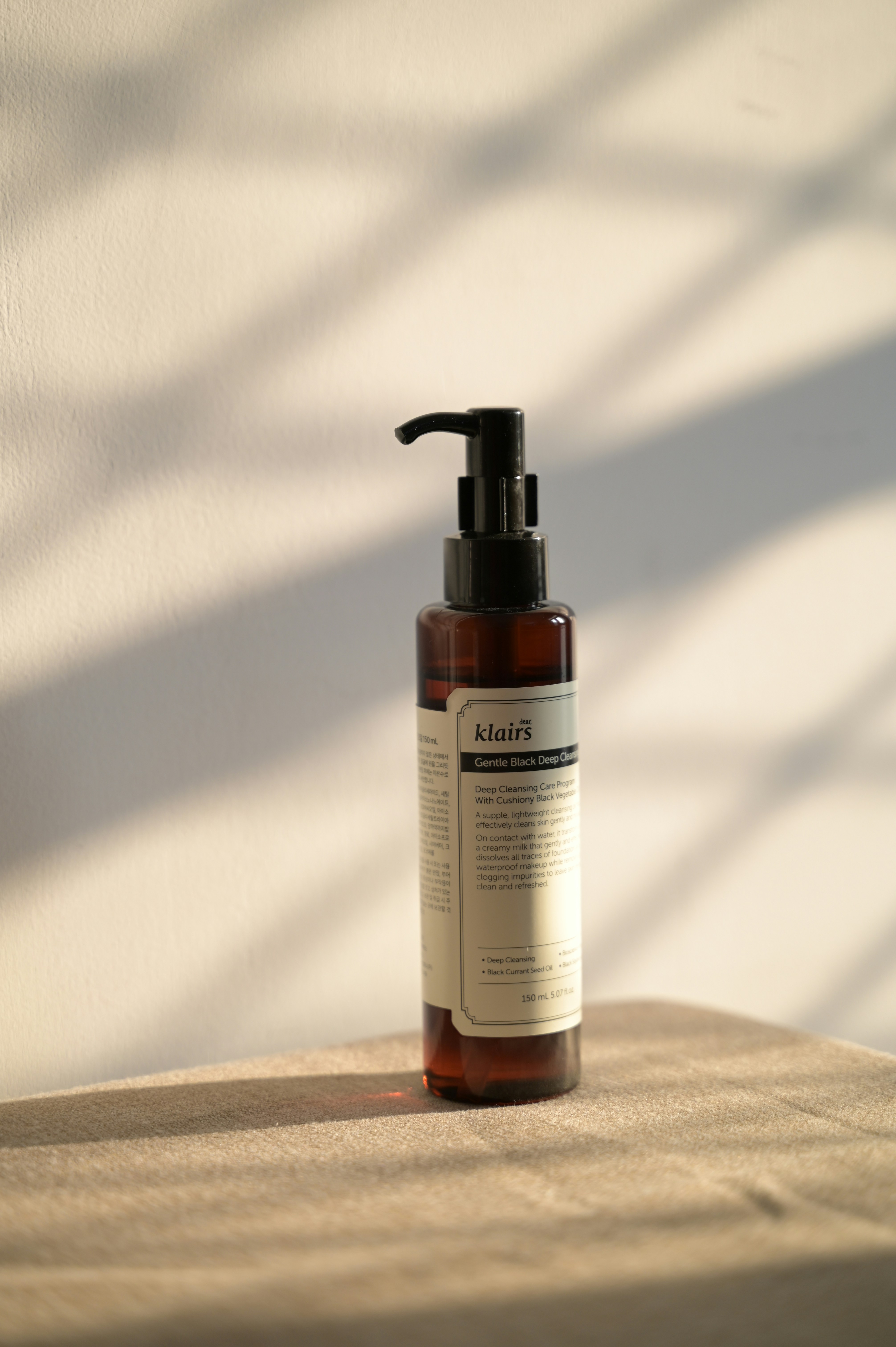 Bottle of skincare product on a table.