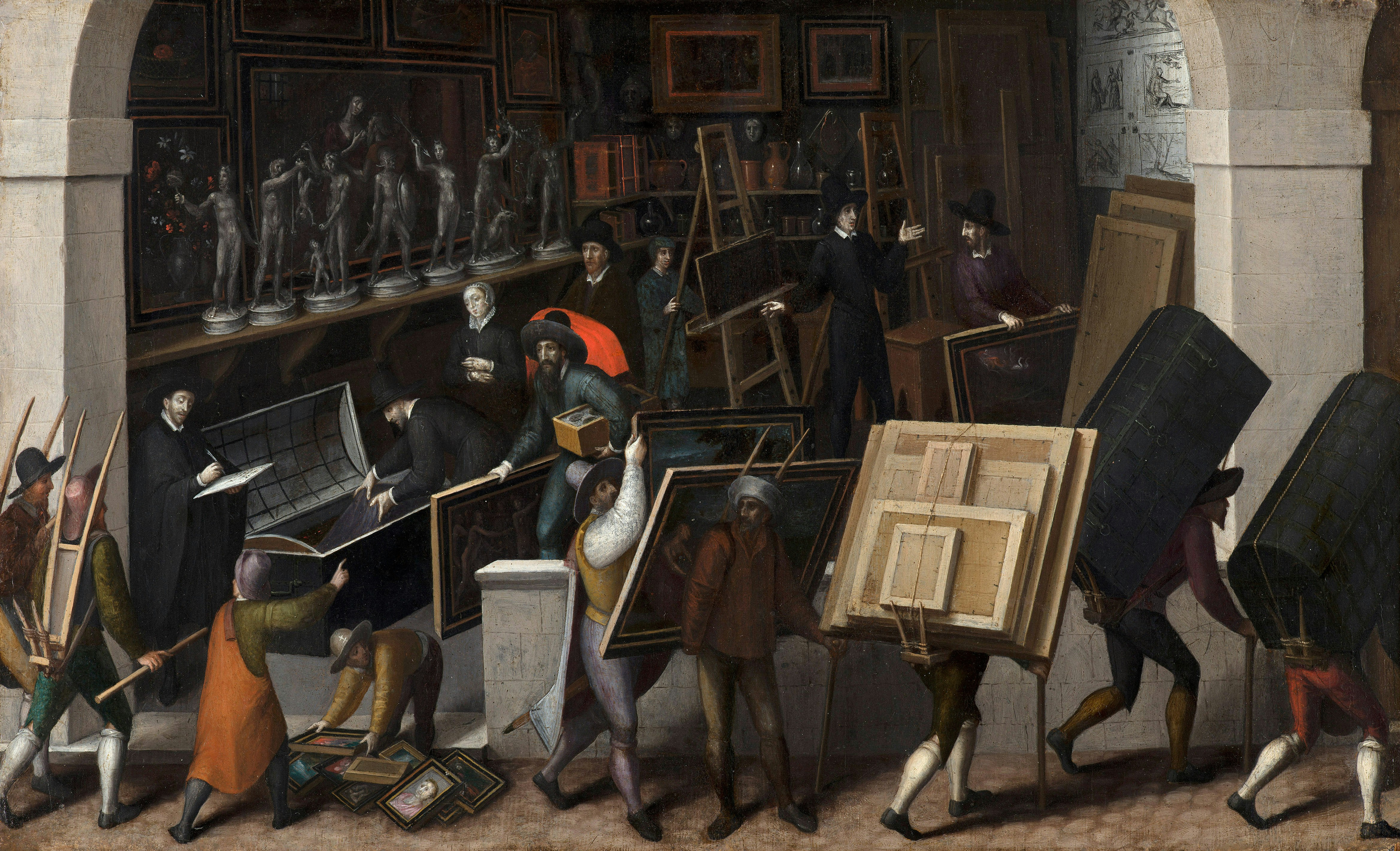 People carrying paintings and sculptures out of a building.