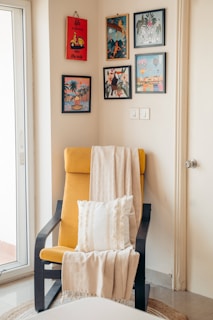 Cozy corner with armchair, art, and a blanket.