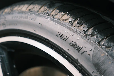 A run-flat tire is visible on a car.