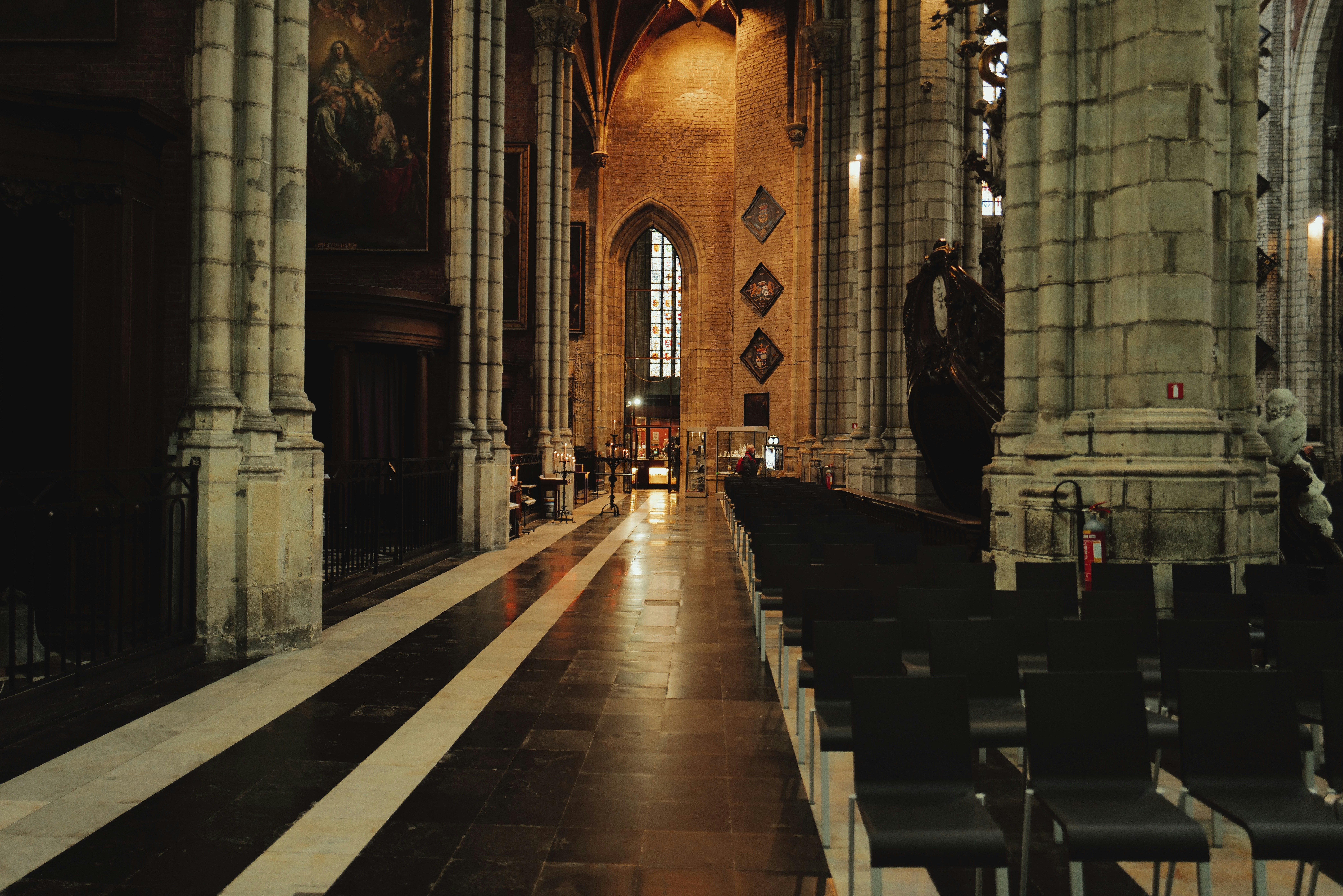 Interior view of a cathedral's aisle and pews.