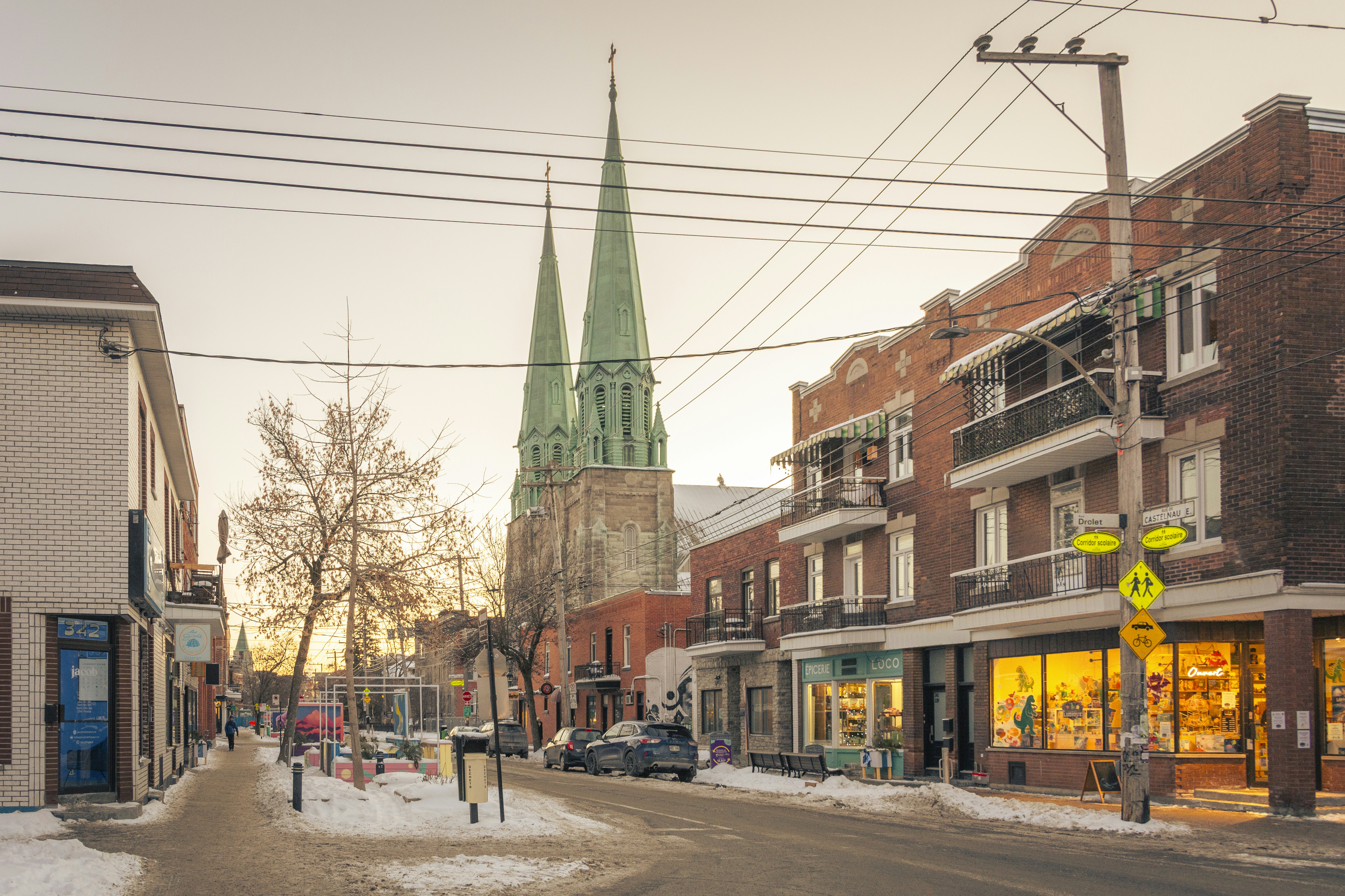 A winter street scene with a church in view.