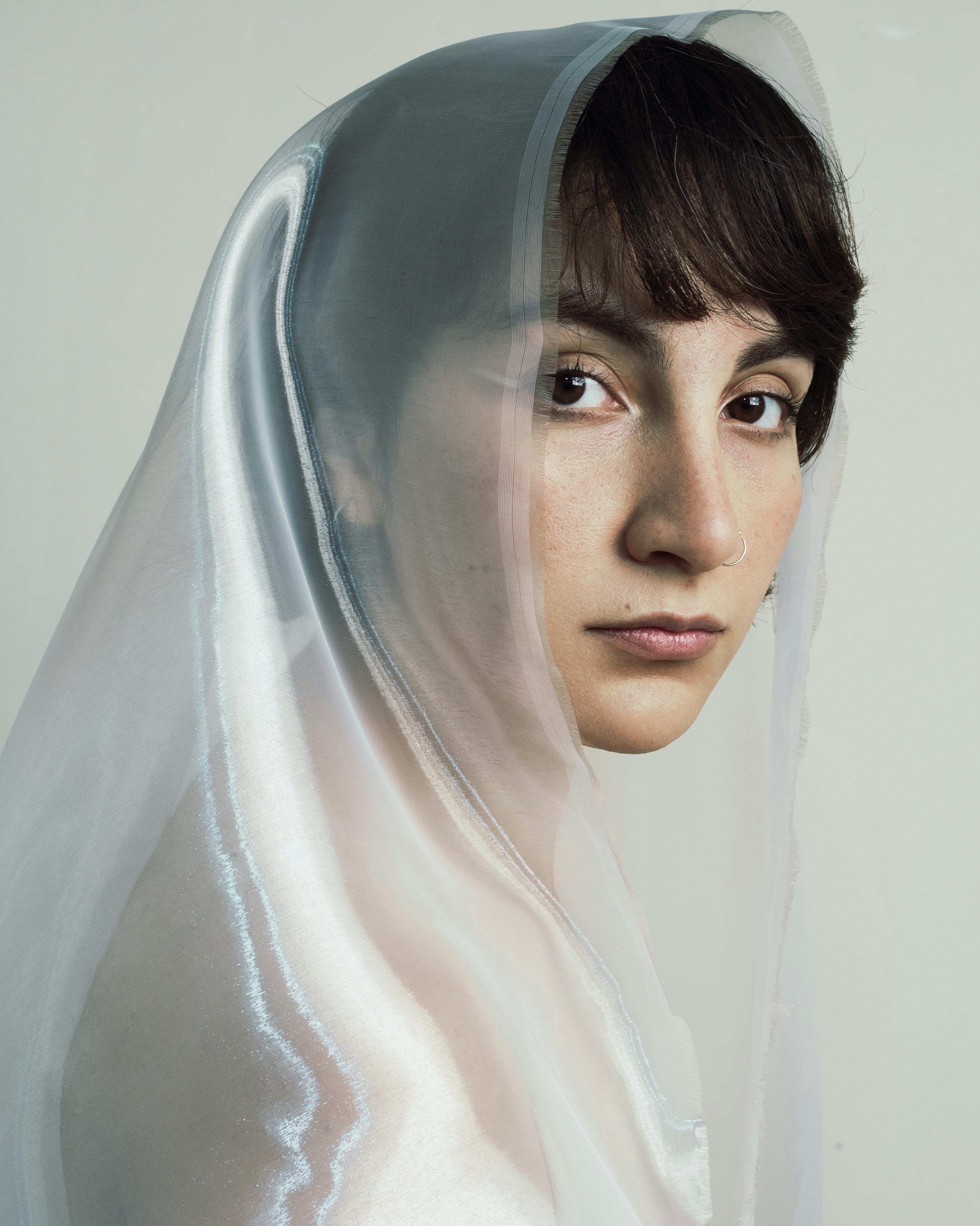 A person wearing a veil gazes intently.