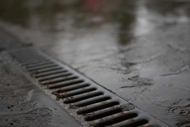 Channel drain carrying runoff off hard surfaces