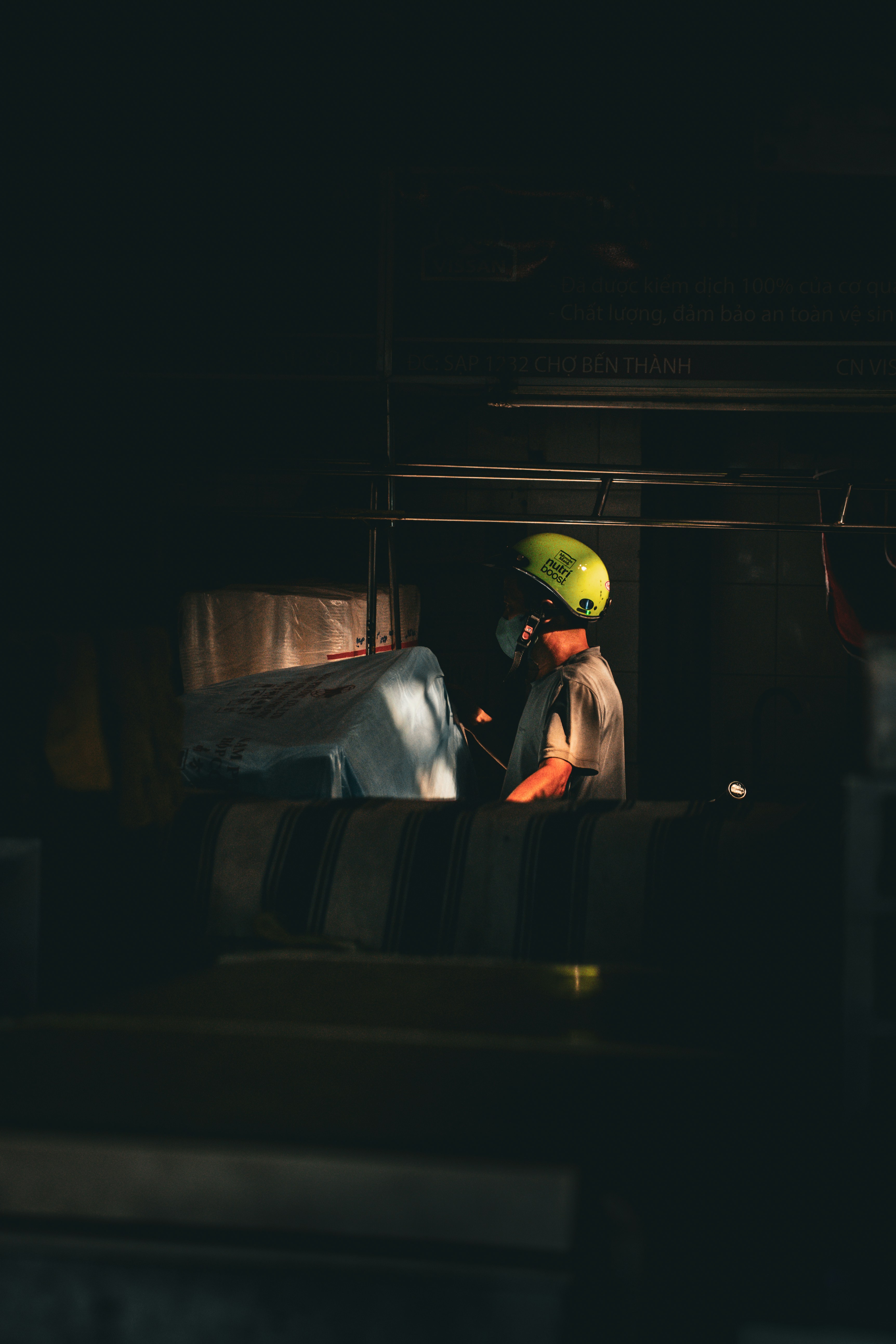 A person wearing a bright green helmet at work.