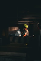 A person wearing a bright green helmet at work.
