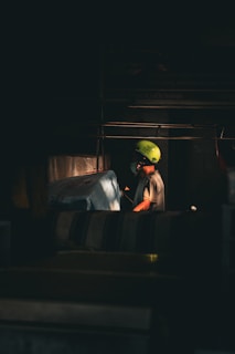 A person wearing a bright green helmet at work.